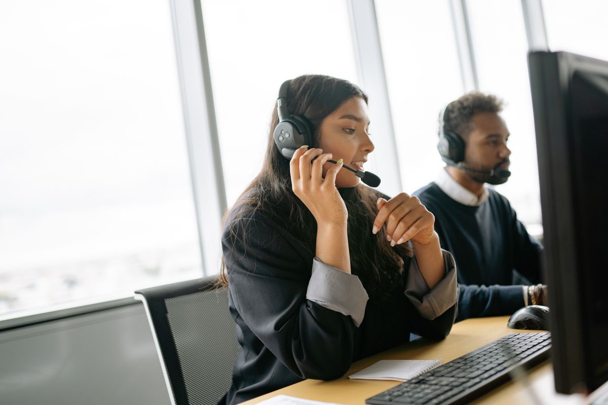 Call center agents on headsets at their desks
